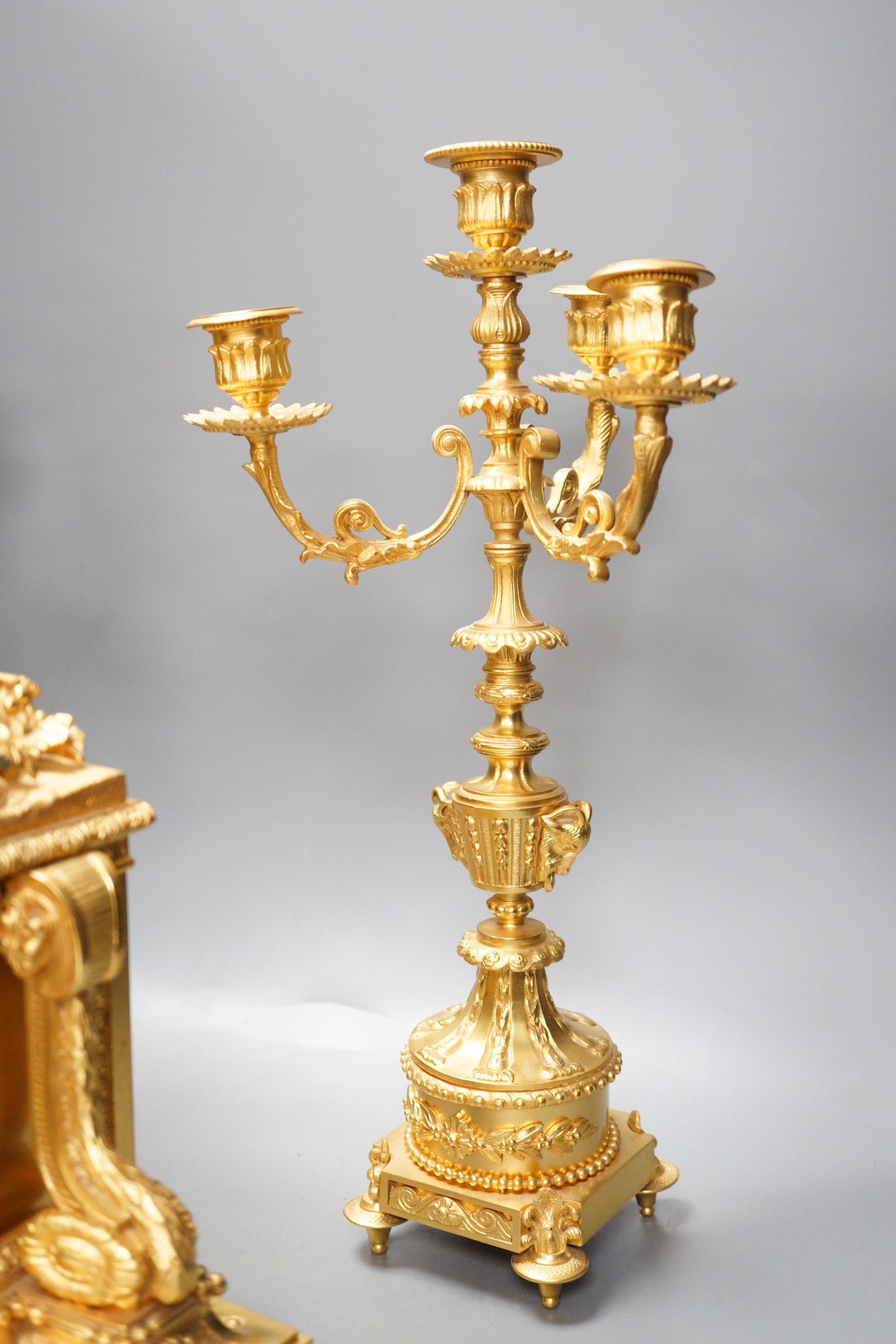 A Louis XVI style ormolu ‘cherub’ clock garniture, late 19th century, with pendulum, 43cm tall